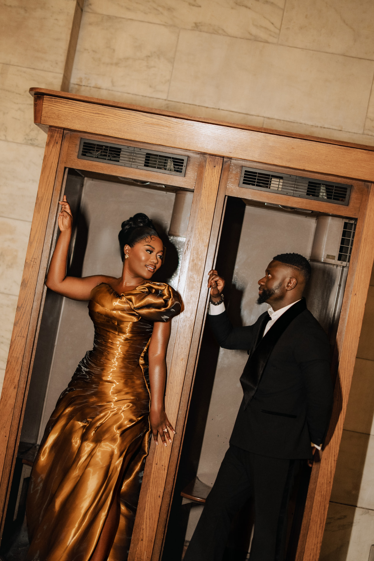 Emmanuel and Priscilla posing by the vintage elevator